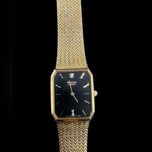 Bulova Gold and Black Rectangular Men's Dress Watch. Discoloration at 6 hr mark
